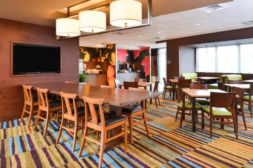 a dining room with a large table and chairs at Fairfield Inn & Suites by Marriott Warrensburg in Warrensburg