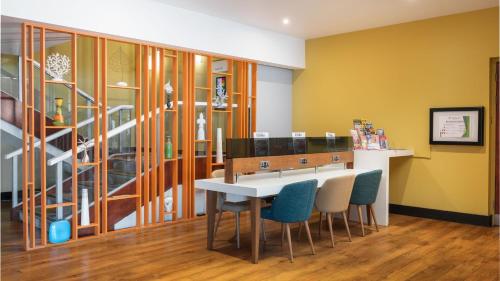 a dining room with a table and chairs at Holiday Inn Brighton Seafront by IHG in Brighton & Hove