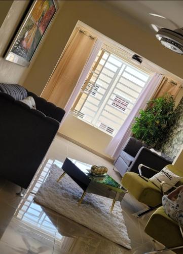 a living room with a couch and a table and a window at Apartmento amueblado in Mendoza