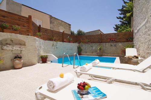a patio with a tub and a swimming pool at Villa Maris in Melissourgákion