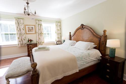 a bedroom with a large bed with a wooden headboard at Barmeath Castle Guest House in Dunleer