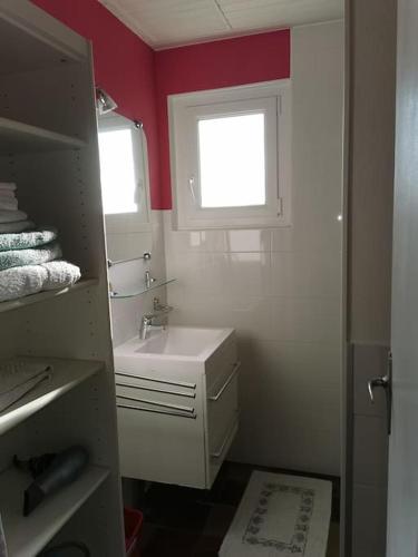 une petite salle de bain avec un lavabo et une fenêtre dans l'établissement Dépendance au calme dans notre jardin, à Saint-Aubin-des-Préaux