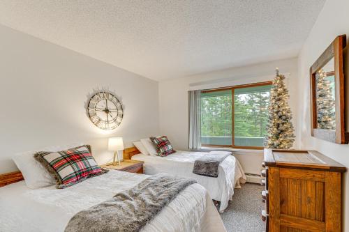 a bedroom with two beds and a christmas tree at Bartlett Condo 1 Mi to Attitash Mountain Resort! in Bartlett