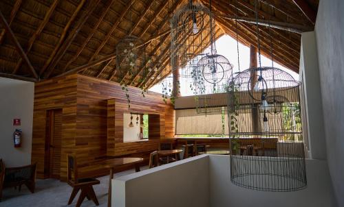 a room with a table and chairs and a large window at Casa del Viento by ÓOL Hotels in Holbox Island