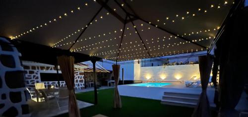 a tent with a swimming pool and lights on it at Villa La Centinela# Luxury San Miguel De Abona in San Miguel de Abona