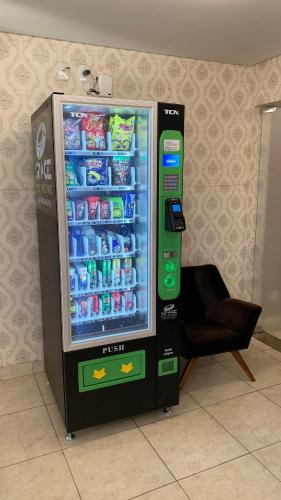 a soda vending machine with drinks inside of it at Infinity Hotel in Goiânia