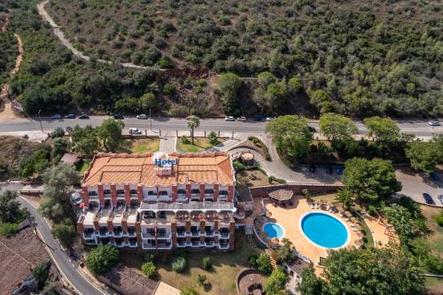 an aerial view of a resort with a pool at Hotel Colina Dos Mouros in Silves