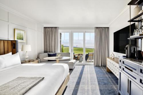 a hotel room with a bed and a living room at The Ritz-Carlton, Half Moon Bay in Half Moon Bay