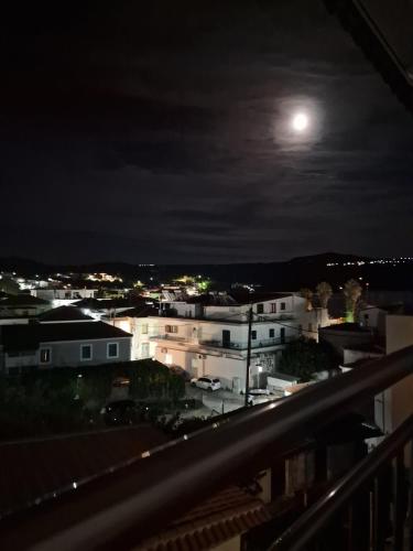 a view of a city at night with the moon at Meteoro 1 in Finikounta