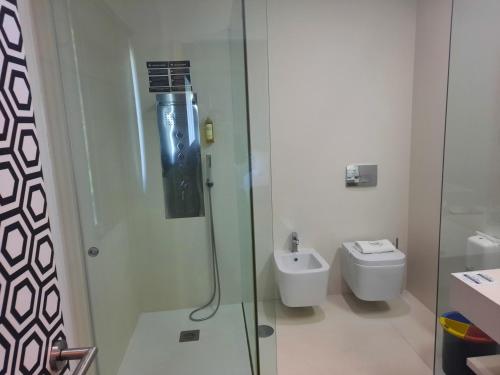 a bathroom with a shower and a toilet at Design & Wine Hotel in Caminha