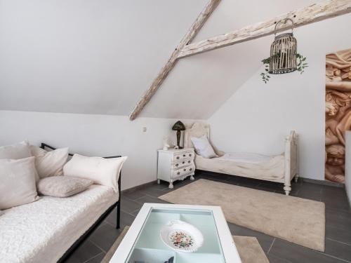a living room with a couch and a table at Luxurious holiday home with a nice private garden in Ditscheid