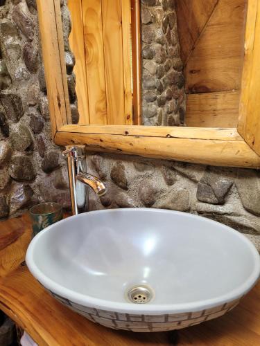 a white sink in a bathroom with a mirror at Nomade Patagonia Glamping & Domos in Trevelin