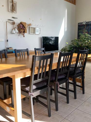 a dining room table with black chairs around it at HAPPY house in Saint-Pierre