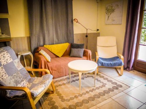 a living room with a couch and chairs and a table at Grand appartement au calme in Lérouville