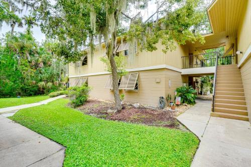 a house with a tree in front of it at Condo with Pool and Beach Access Near Theme Park in Deltona