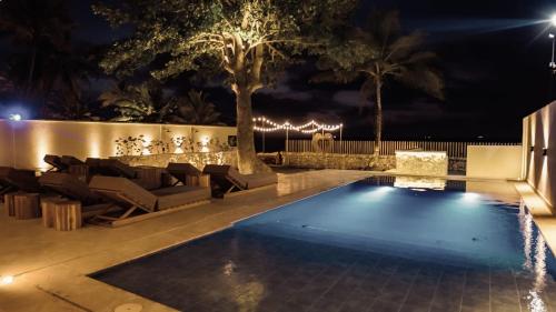 a swimming pool in a yard at night at Talam House Coveñas by Bernalo Hotels in Coveñas