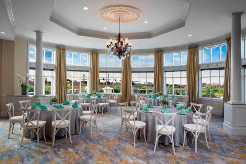 a banquet hall with tables and chairs and a chandelier at The Westin Savannah Harbor Golf Resort & Spa in Savannah