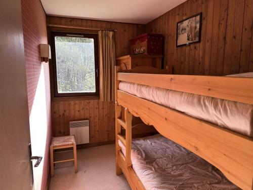 a bedroom with two bunk beds and a window at Chalet Lombard - CHALET 10 PERSONNES MAE-2711 in Combloux