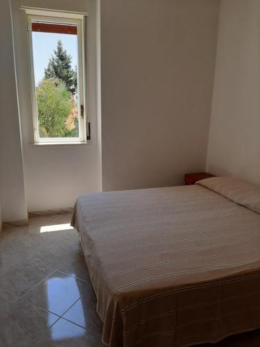 Postel nebo postele na pokoji v ubytování Residence Conca D'oro