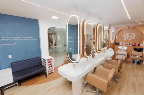 a salon with a row of mirrors in a room at Blue Tree Premium São Luis in São Luís