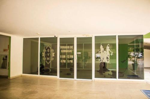 a room with glass doors with a horse on the wall at PH ocean view, Playa corona in La Chumicosa