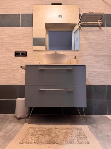 a bathroom with a sink and a mirror at B&B Cà dei Nonni di Barbero Chiara in Calliano