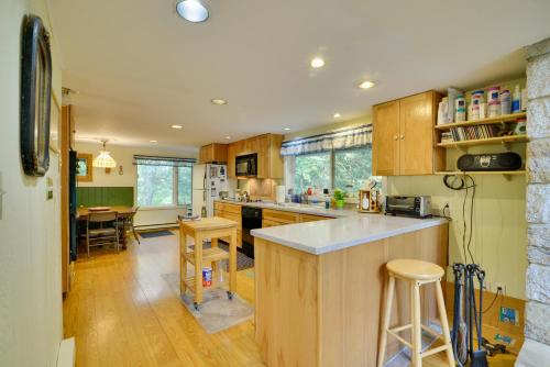 a kitchen with wooden cabinets and a counter top at Secluded Stroudsburg Home - 5 Mi to Ski Resort in Stroudsburg