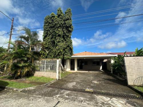 uma casa com uma grande árvore na entrada da garagem em Casa Doleguita em David