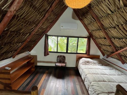 a living room with a couch and a window at Xanthus Hotel in Huay Pix