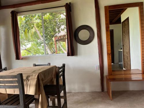 a dining room with a table and a window at Xanthus Hotel in Huay Pix