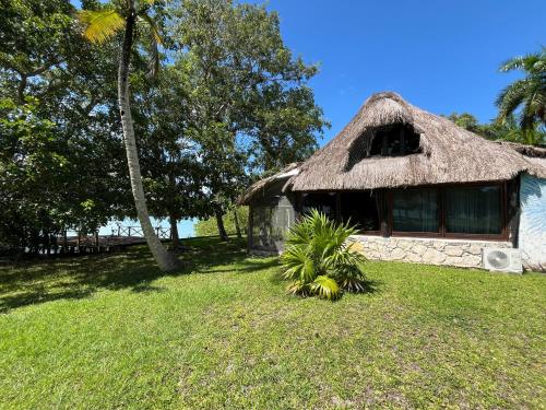 a thatch roofed house with a grass roof at Xanthus Hotel in Huay Pix