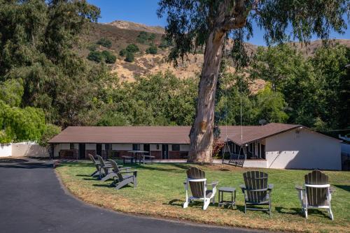a group of chairs sitting in front of a building at Peach Tree Inn in San Luis Obispo