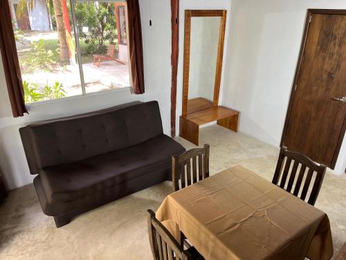 a living room with a couch and a table at Xanthus Hotel in Huay Pix