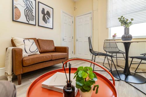 a living room with a couch and a table at Kasu Lodge - Sneinton, Nottingham in Nottingham