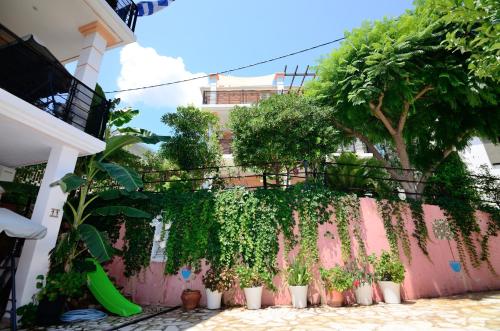 a wall with plants on it next to a building at Villa Ektoras II by EY Villas in Parga