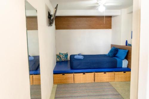 a bedroom with a blue bed in a room at Casa Arrecife Tortuga, Fast Internet, private Cozy room in La Ventana
