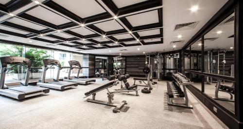 a gym with several treadmills and cardio machines at Army Hotel in Hanoi
