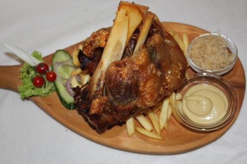 a plate of food with a chicken and french fries at Motelnet.T in Mosonmagyaróvár