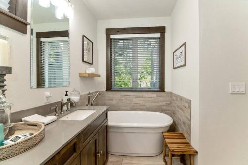 a white bathroom with a toilet and a sink at Smore Days Plz in Cle Elum