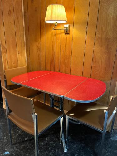 a ping pong table with two chairs around it at Sleeping Bear Riverside Cabins in Honor