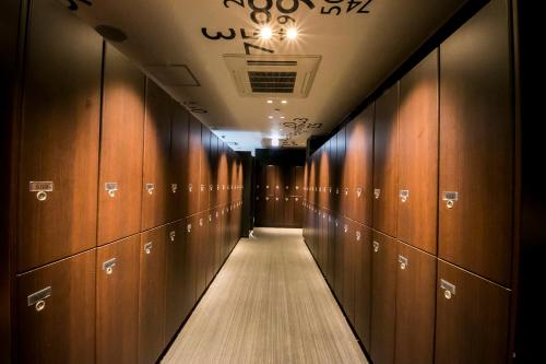 a row of lockers in a locker room at Spa&Capsule Hotel Grandpark Inn Kitasenju in Tokyo
