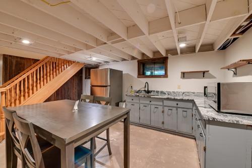 a large kitchen with a table and a staircase at Red River Gorge Cabin Hike and Relax! in Rogers