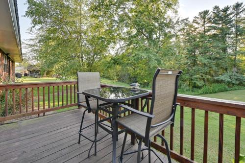 a table and two chairs on a deck at Cabin Getaway Near Red River Gorge Recreation in Rogers