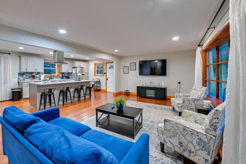 a living room with blue couches and a kitchen at Cabin Getaway Near Red River Gorge Recreation in Rogers