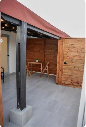 a large room with a table and a wooden wall at North Breeze Guest House 3 in Toa Baja