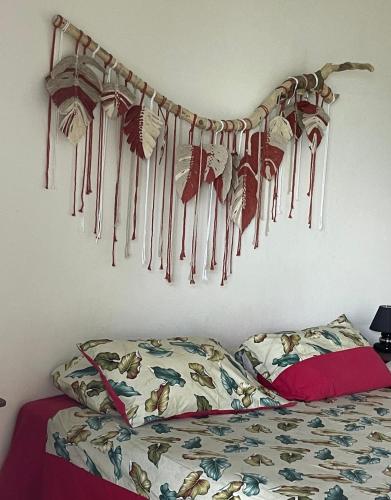 a bedroom with a bunch of dream strings hanging on the wall at PK 35 in Apomaoro