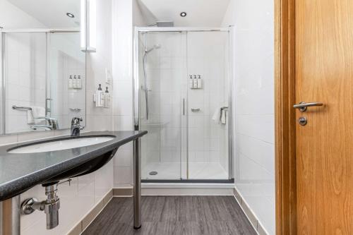a bathroom with a sink and a shower at Park Inn by Radisson Peterborough in Peterborough