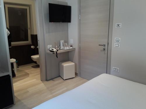 a hotel room with a bed and a phone at Hotel Danieli La Castellana lago di Garda in Brenzone sul Garda