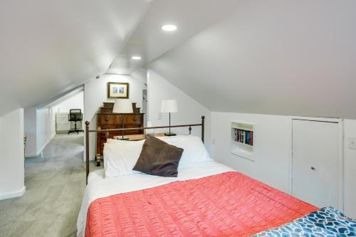 a bedroom with a bed with a red blanket at 5 Mi to Mall of America South Minneapolis Home in Minneapolis
