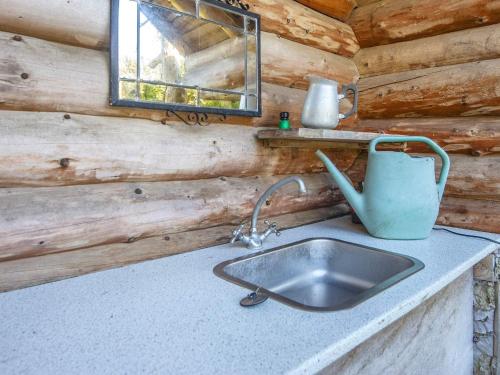 a kitchen sink in a log cabin with a window at 7 person holiday home in Lemvig-By Traum in Lemvig